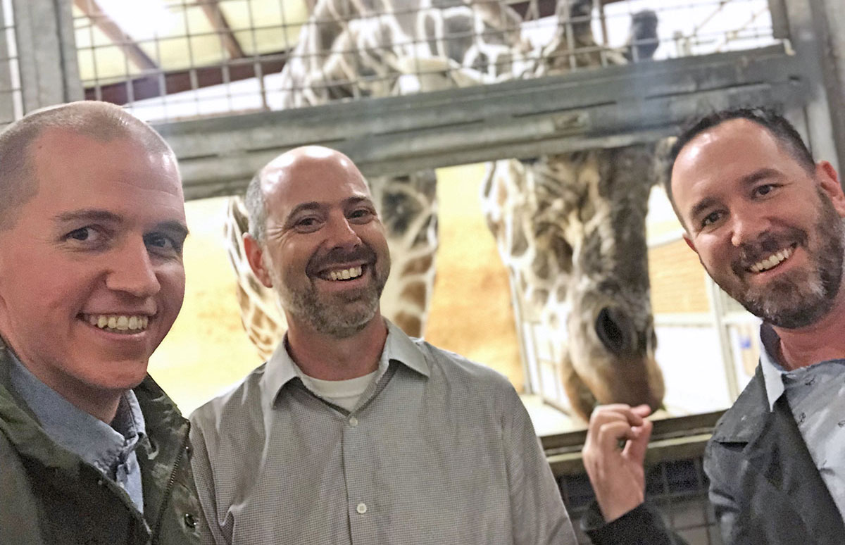 A picture of Tighten team members at a Giraffe habitat at the Fort Wayne Zoo.