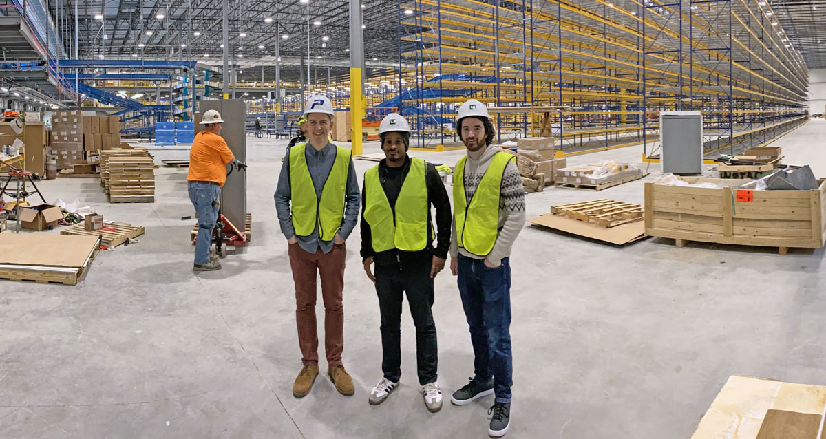 A picture of Tighten team members touring the Sweetwater warehouse facility